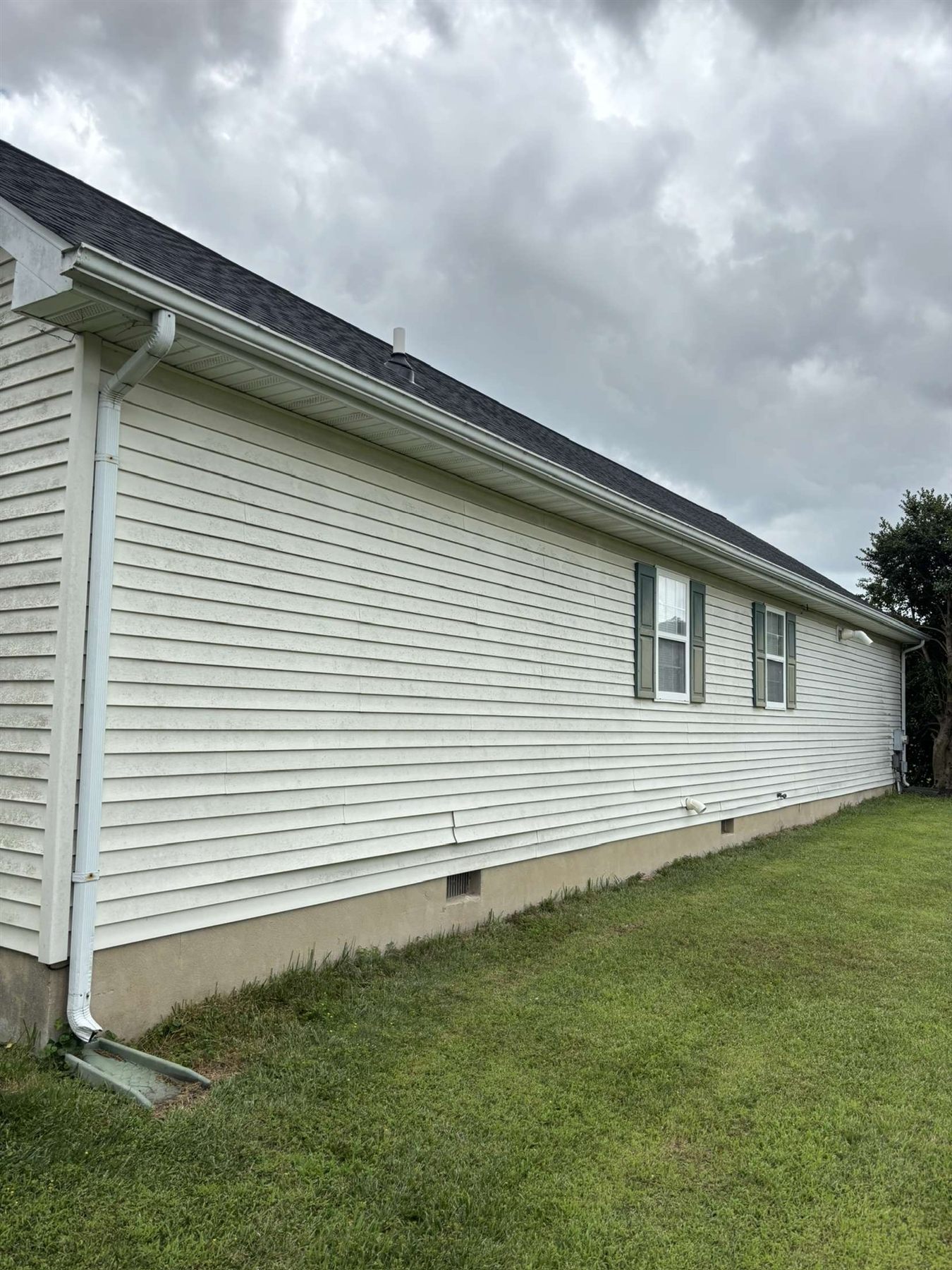 Before house washing in Milford Delaware showing stained siding