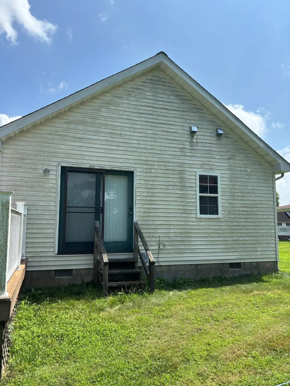 Stained vinyl siding on the rear gable before washing